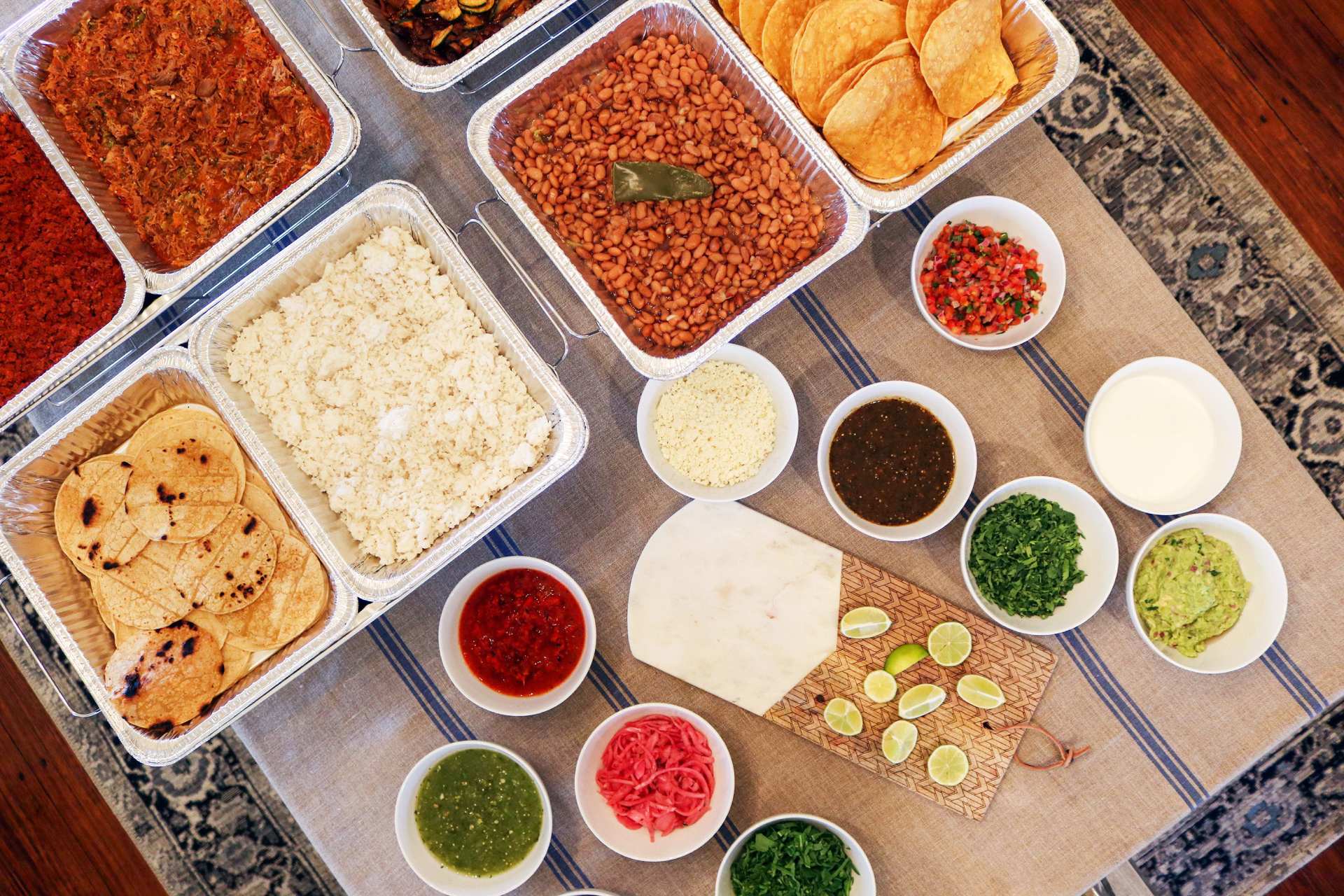 A spread of tacos Kept on a wooden table